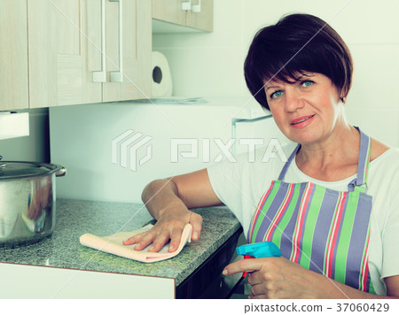 retiree woman cleaning home 37060429