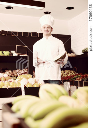 Handsome male chef looking for fresh fruits Handsome male chef looking for fresh fruits 37060488