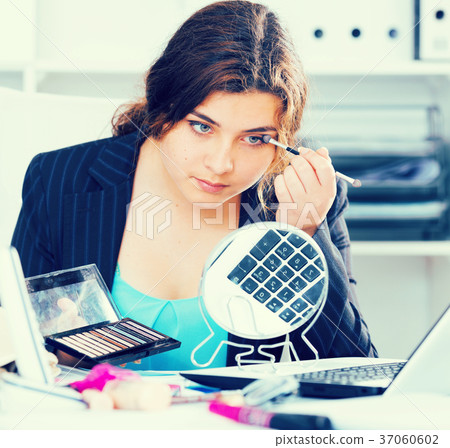 Beginner businesswoman is making makeup before meeting Beginner businesswoman is making makeup before meeting 37060602