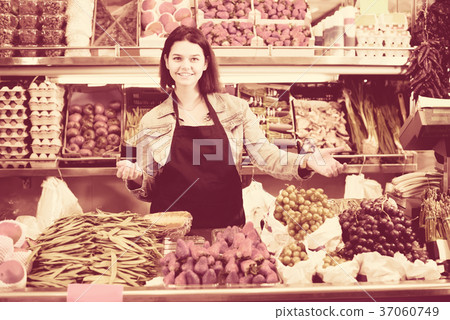 Female shopping assistant demonstrating assortment of grocery shop 37060749