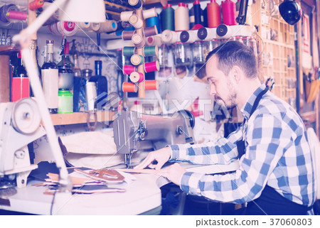 Professional man worker qualitatively stitching belt 37060803