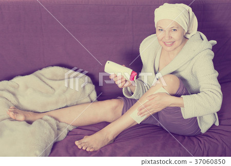 Woman doing body hair removal 37060850