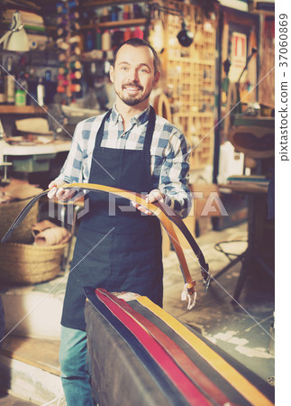 Worker demonstrating assortment in leather 37060869