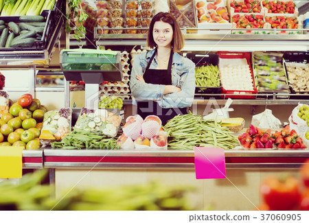 Ordinary woman seller displaying assortment 37060905
