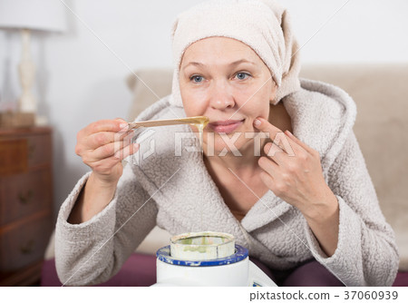 Woman doing body hair removal Woman doing body hair removal 37060939