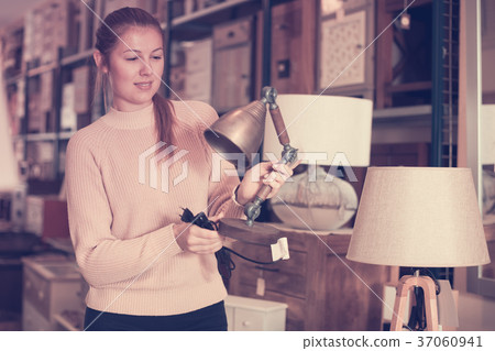 cheerful woman buyer choosing lamp cheerful woman buyer choosing lamp 37060941