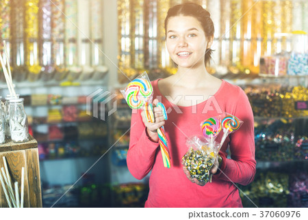 girl buying candies at shop girl buying candies at shop 37060976