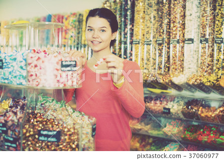 girl buying candies at shop 37060977