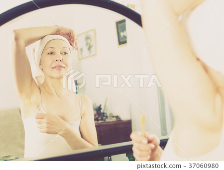 Woman doing body hair removal Woman doing body hair removal 37060980