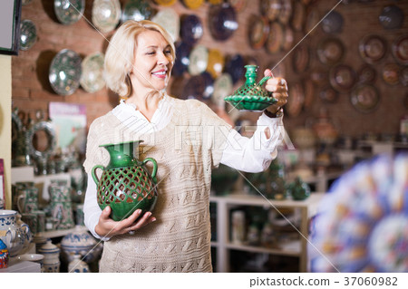 Mature woman posing with ceramic tableware Mature woman posing with ceramic tableware 37060982