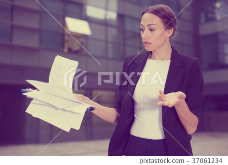 Serious woman is dissatisfied of the results of the financial report 37061234