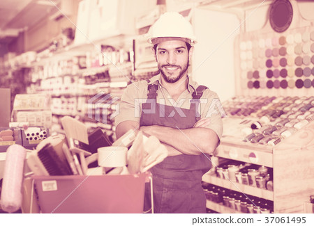 Workman standing folded arms near basket with picked tools in pa Workman standing folded arms near basket with picked tools in pa 37061495