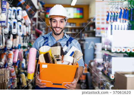 Smiling man builder with tools in hands in shop 37061620