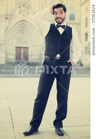 Man adjusting hairstyle outdoors 37061624