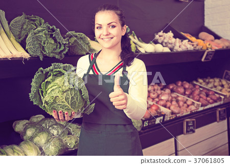 Seller displaying assortment of grocery shop Seller displaying assortment of grocery shop 37061805