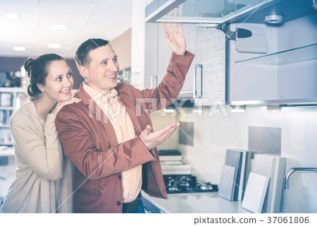Couple looking at modern kitchen 37061806