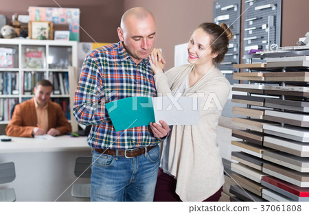 couple browsing the catalog with kitchen furniture couple browsing the catalog with kitchen furniture 37061808