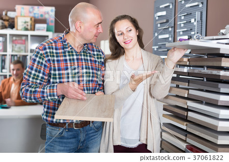 Couple selects material for kitchen furniture Couple selects material for kitchen furniture 37061822