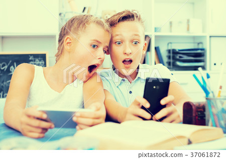 Boy is watching interesting video with in his smartphone with girlfriend Boy is watching interesting video with in his smartphone with girlfriend 37061872