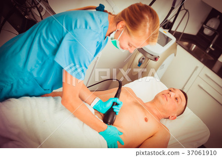 Female doctor is doing vacuum massage procedure for anti-fat to patient Female doctor is doing vacuum massage procedure for anti-fat to patient 37061910