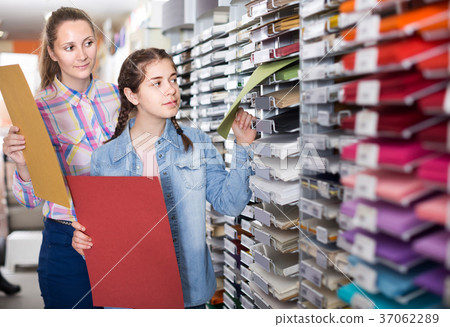 woman and girl shopping multicolored paper in art store woman and girl shopping multicolored paper in art store 37062289