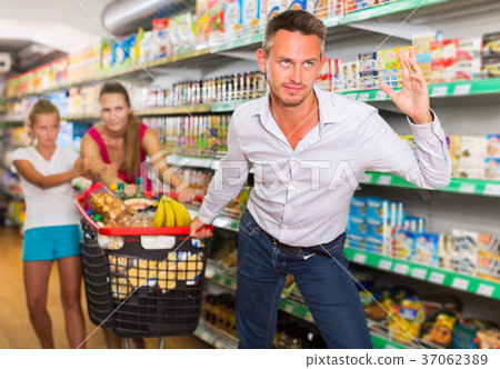 frustration man with family in supermarket frustration man with family in supermarket 37062389