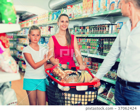 Positive family with teen daughter and purchases in shopping 37062424