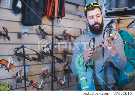 Man choosing climbing equipment 37062610