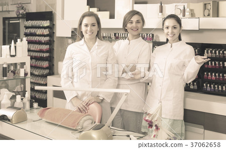 Portrait of professional manicurists at working place inviting to salon Portrait of professional manicurists at working place inviting to salon 37062658