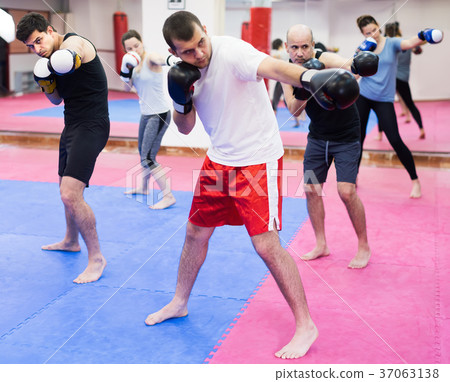 Men and woman practicing in the boxing hall 37063138