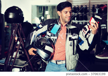Man choosing moto gloves 37063199