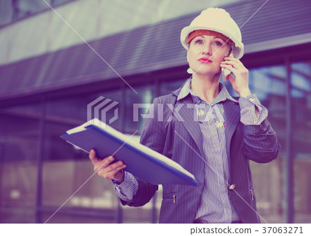 Portrait of employee woman talking phone Portrait of employee woman talking phone 37063271