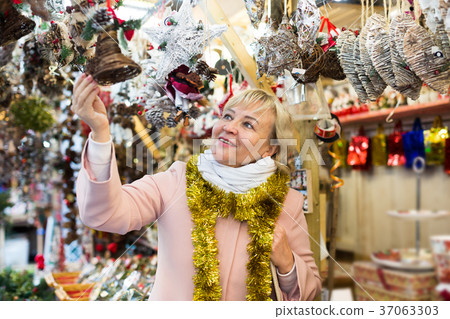 female in tinsel choosing decoration 37063303