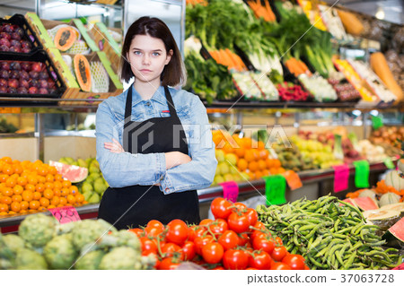 Female seller displaying assortment 37063728