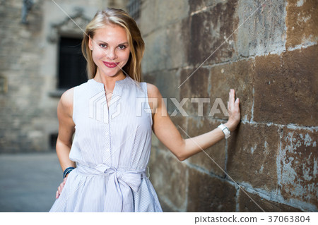 smiling woman near the stone wall smiling woman near the stone wall 37063804
