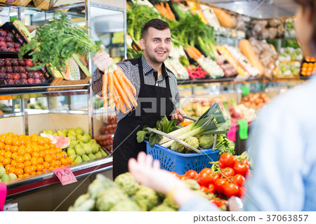 Male seller assisting in buying Male seller assisting in buying 37063857