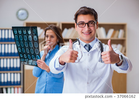 图库照片 young doctor looking at computer tomography x-ray