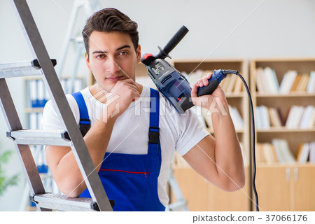 Repairman working with drilling drill perforator 37066176