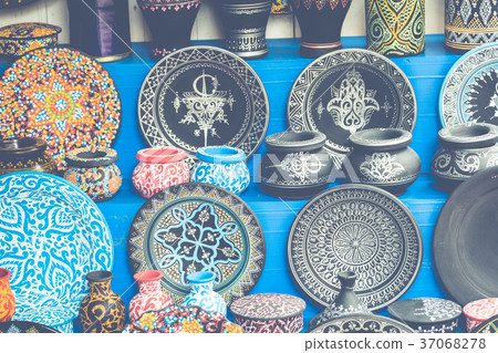 Plates, tajines and pots made of clay on the souk Plates, tajines and pots made of clay on the souk 37068278