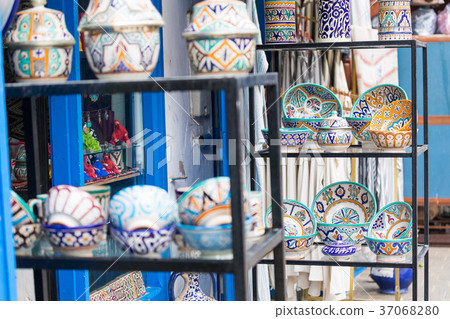 Plates, tajines and pots made of clay on the souk Plates, tajines and pots made of clay on the souk 37068280