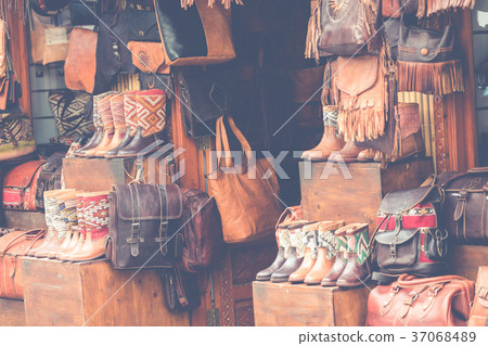 Moroccan leather goods bags and slippers at market 37068489