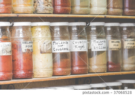 Assortment of glass jars on shelves in shop Assortment of glass jars on shelves in shop 37068528