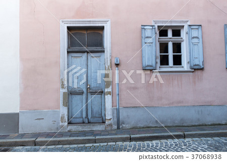 Blue old door and a window in a town 37068938