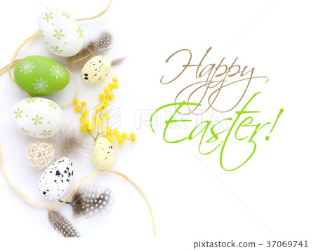 Easter eggs and mimosa flowers on white background Easter eggs and mimosa flowers on white background 37069741