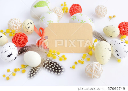 Easter eggs and mimosa flowers on white background Easter eggs and mimosa flowers on white background 37069749