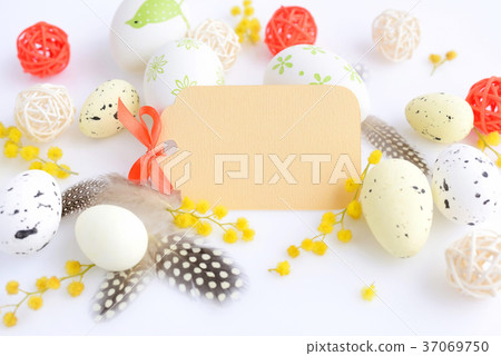Easter eggs and mimosa flowers on white background Easter eggs and mimosa flowers on white background 37069750
