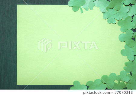 Shamrocks on a blank paper sheet 37070318