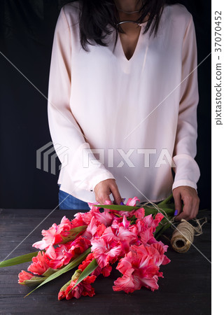 women's hands create a bouquet of flowers of women's hands create a bouquet of flowers of 37070452