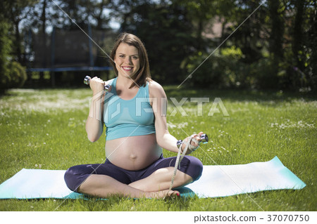 Pregnant woman with fitness 37070750