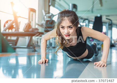 Asian woman fitness girl do pushing ups at fitness Asian woman fitness girl do pushing ups at fitness 37071487